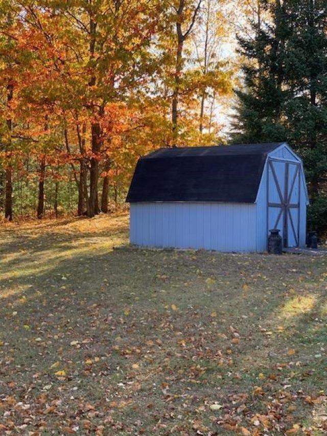 view of outdoor structure with a lawn