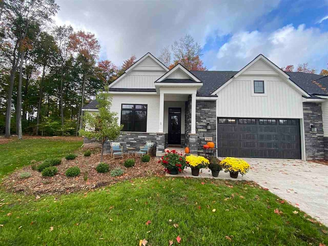 view of front of home featuring a garage and a front lawn