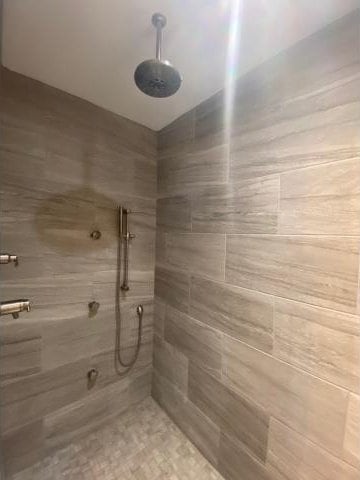 bathroom with a tile shower