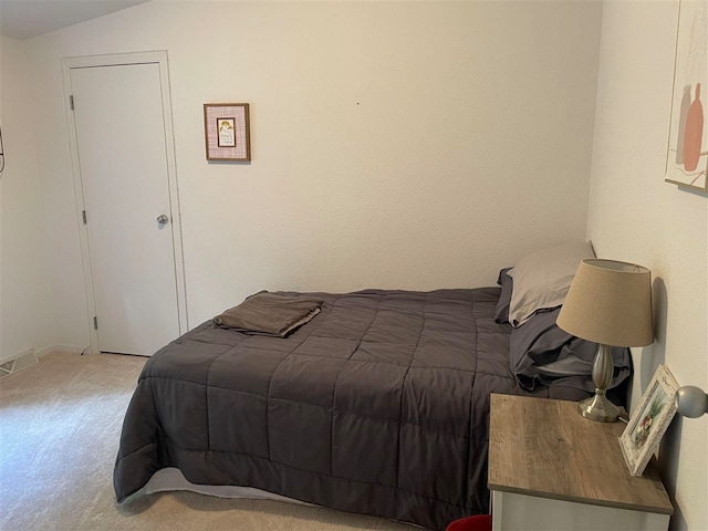 bedroom with lofted ceiling and carpet floors