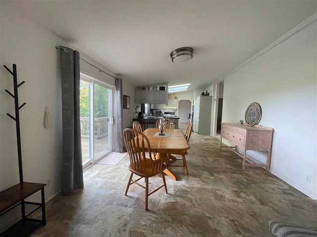 dining area featuring vaulted ceiling