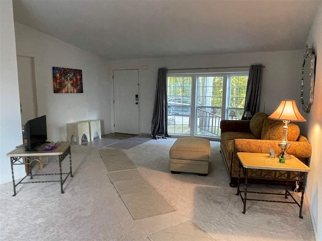 carpeted living room featuring vaulted ceiling