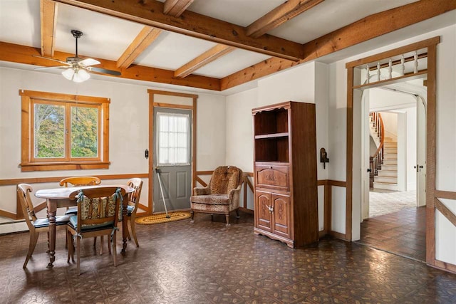 dining area with ceiling fan and beamed ceiling