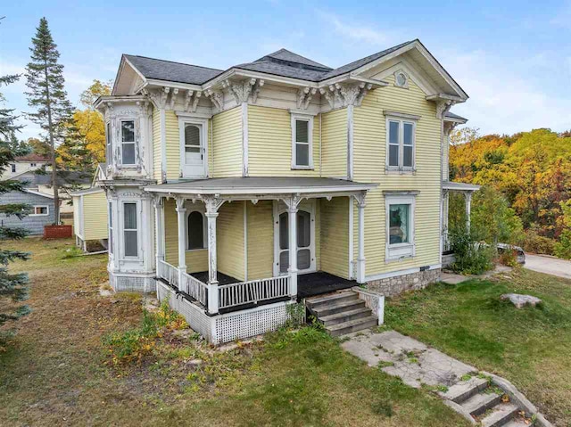 italianate-style house with a front lawn and covered porch