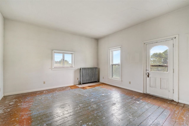 entrance foyer featuring light wood-type flooring and radiator heating unit