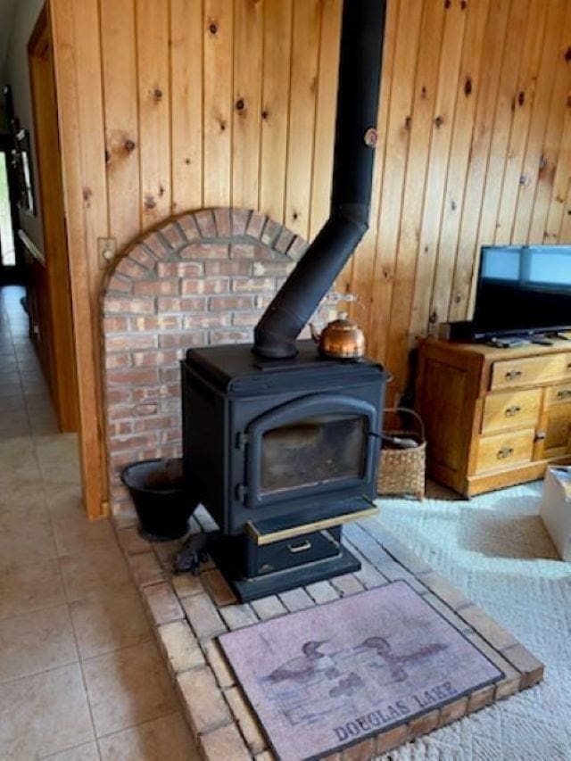 interior details with a wood stove and wood walls