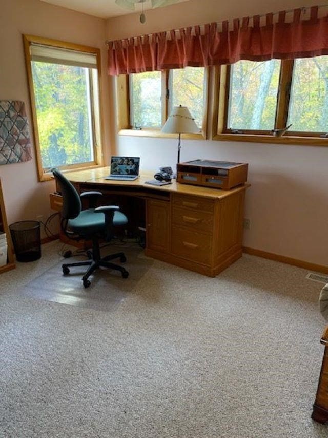 home office with carpet, a healthy amount of sunlight, and ceiling fan