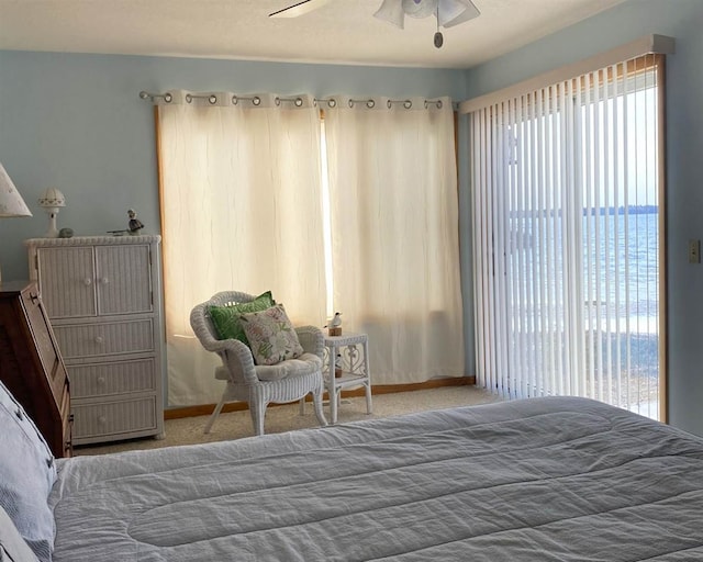 bedroom featuring a water view, carpet floors, and ceiling fan