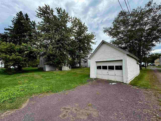 garage featuring a lawn