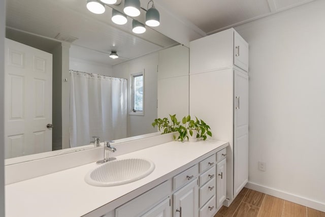 bathroom with vanity and hardwood / wood-style floors