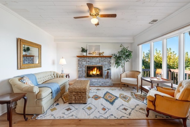 living room featuring ornamental molding, a brick fireplace, and hardwood / wood-style floors