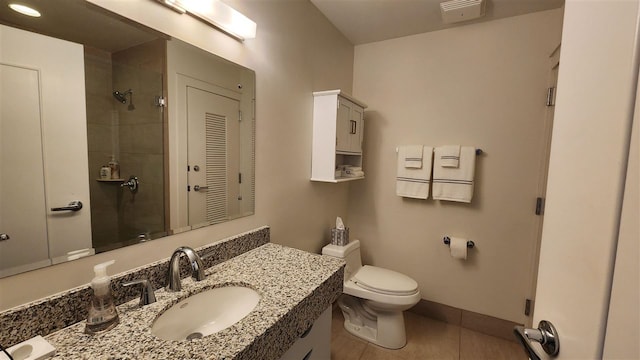 bathroom featuring vanity, toilet, a shower with shower door, and tile patterned flooring