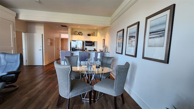 dining space featuring dark hardwood / wood-style floors