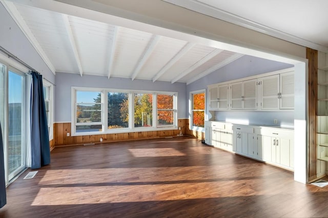 unfurnished sunroom with vaulted ceiling with beams