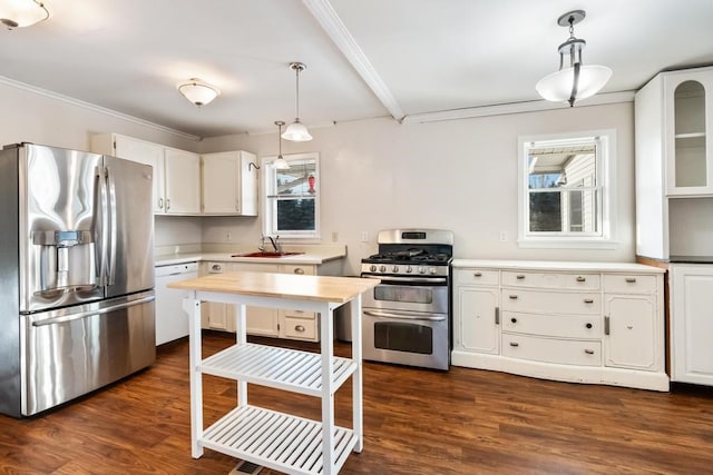 kitchen with white cabinetry, appliances with stainless steel finishes, and decorative light fixtures