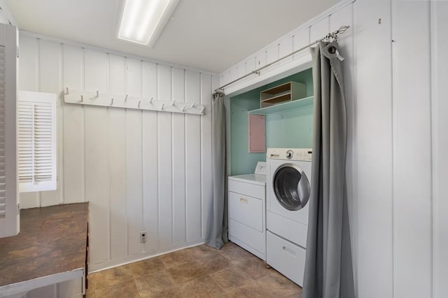 clothes washing area featuring separate washer and dryer