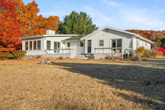 back of house featuring a yard