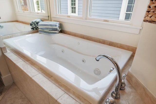 bathroom with tile patterned flooring and tiled tub