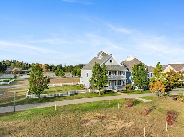 view of front of property with a front lawn and a balcony