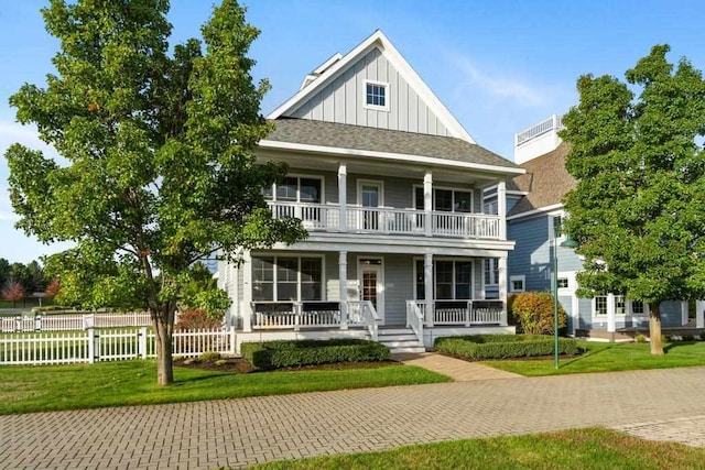 view of front of house with a porch, a front lawn, and a balcony