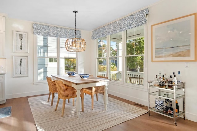 dining area with an inviting chandelier and wood-type flooring