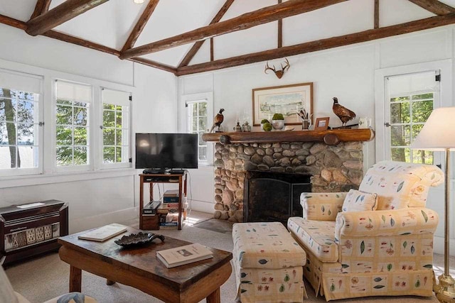 carpeted living room with beamed ceiling, a stone fireplace, and high vaulted ceiling