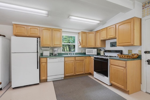 kitchen with white appliances, vaulted ceiling, light brown cabinets, and sink