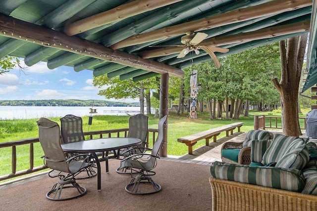 view of patio / terrace with a deck with water view and ceiling fan