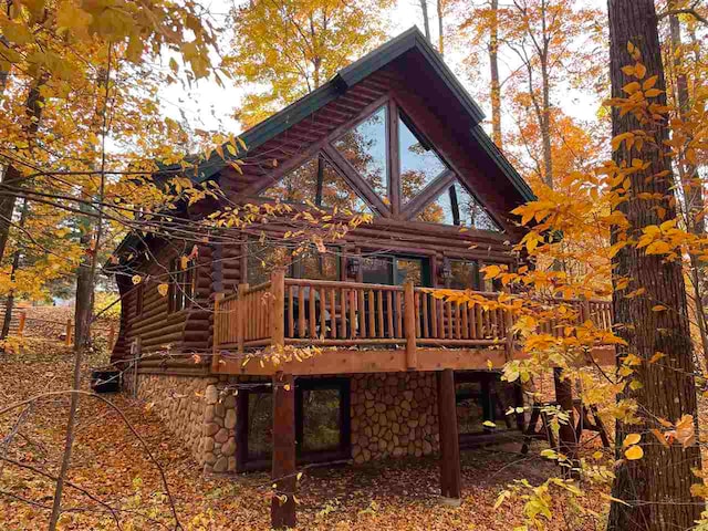 rear view of house with a wooden deck