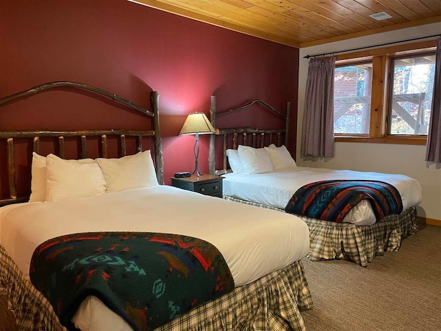 bedroom with carpet and wood ceiling