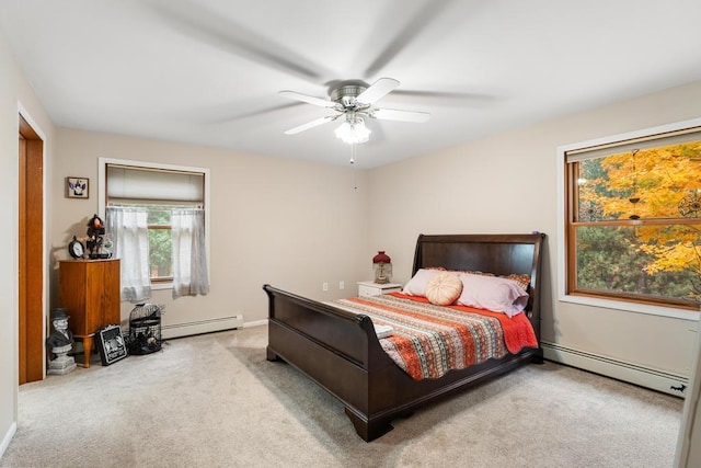 carpeted bedroom with baseboard heating and ceiling fan