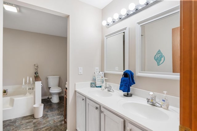 bathroom with a bathtub, toilet, and vanity