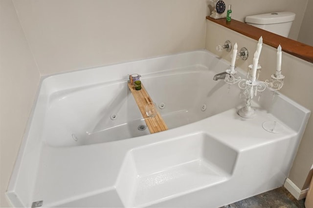 bathroom with toilet and a washtub