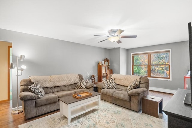 living room with ceiling fan and light wood-type flooring