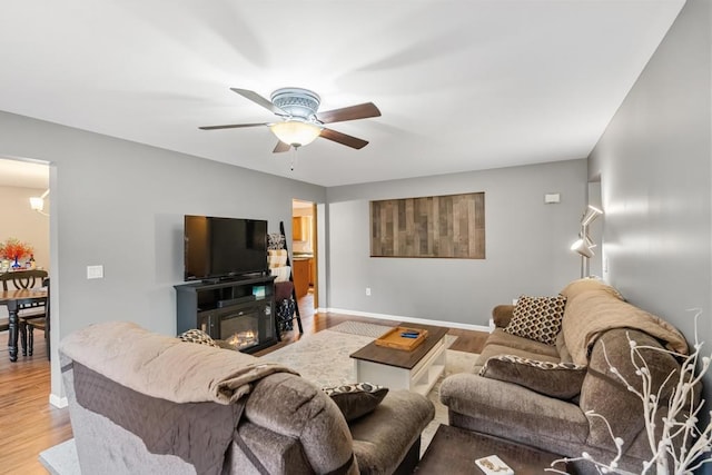 living room with wood-type flooring and ceiling fan