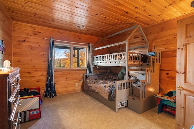 carpeted bedroom with wood ceiling and wood walls