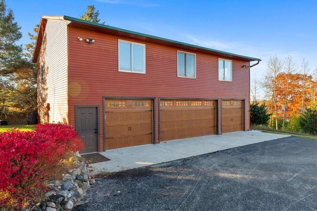 view of side of home with a garage