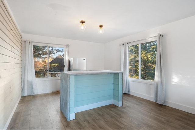 interior space featuring dark hardwood / wood-style floors and stainless steel refrigerator