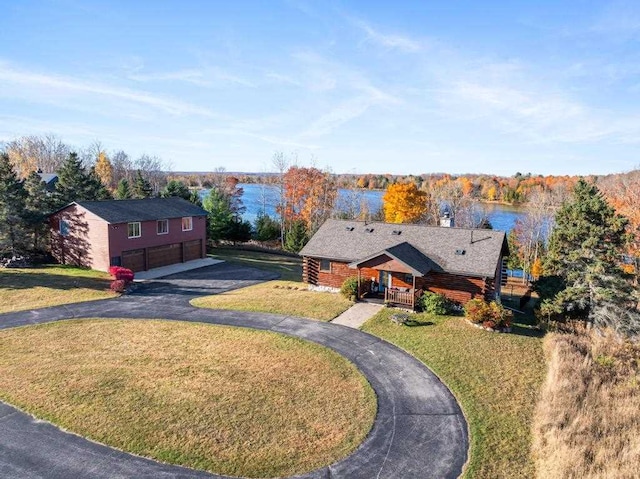 view of front of house with a front lawn and a water view