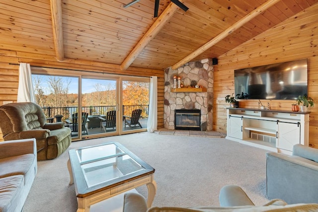 carpeted living room featuring beam ceiling, a stone fireplace, wooden ceiling, and wood walls