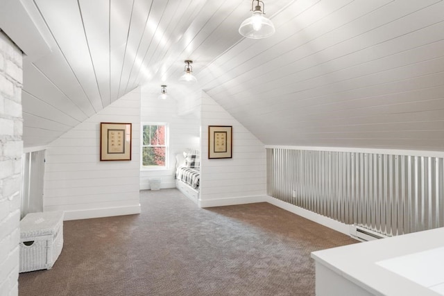 bonus room with wood walls, lofted ceiling, a baseboard heating unit, and dark colored carpet