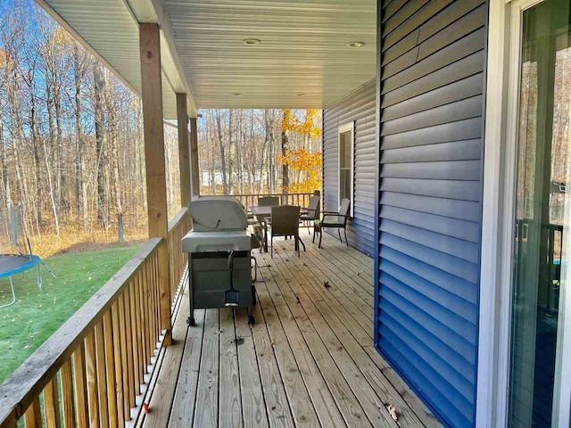 deck with grilling area and a trampoline