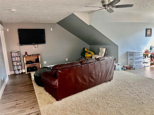 home theater room featuring hardwood / wood-style flooring, ceiling fan, a textured ceiling, and vaulted ceiling