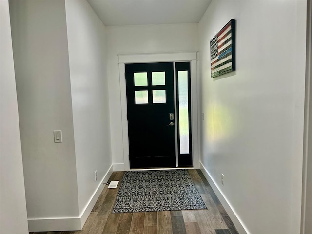 doorway with dark wood-type flooring