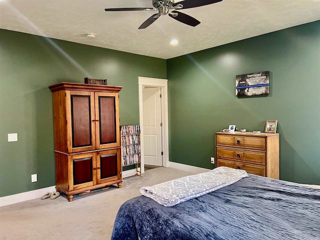 bedroom with ceiling fan and light carpet