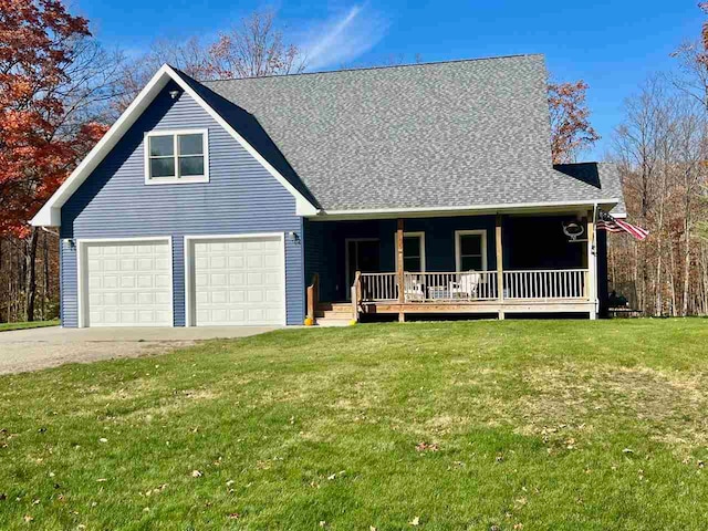 view of front facade featuring a front yard, a garage, and covered porch