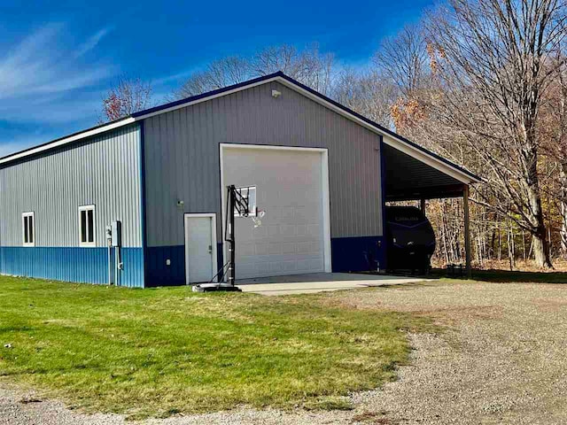 view of outbuilding with a yard and a garage