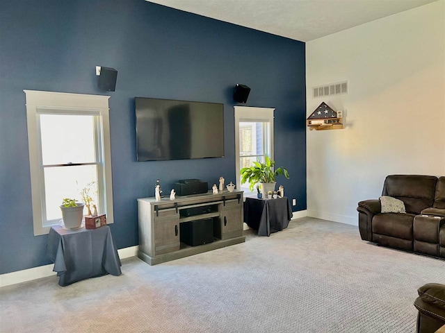 living room with light carpet and a high ceiling