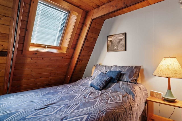 bedroom with lofted ceiling, wooden walls, and wooden ceiling