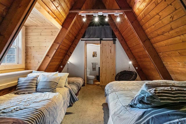 bedroom featuring carpet flooring, a barn door, ensuite bath, wood ceiling, and lofted ceiling